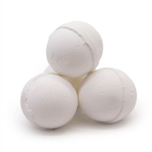 Stack of white bath bombs on plain background